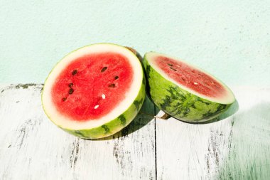 Slice of ripe watermelon on white wood table, summer concept.