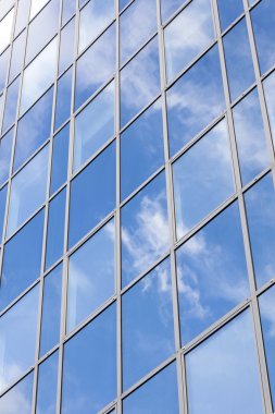 Mavi gökyüzü ve bulutlar cam ofis cephe yansıtır