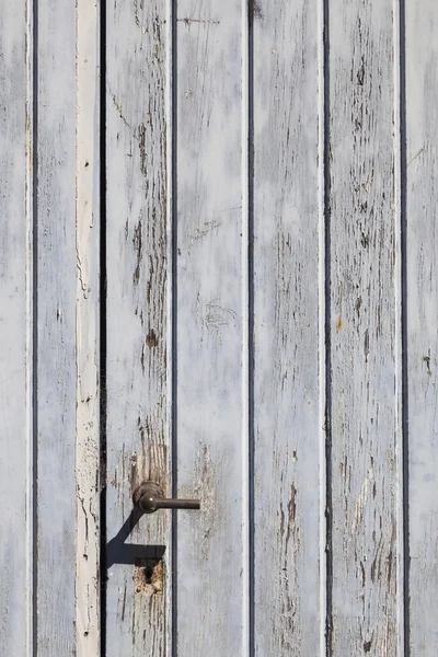 Vertical part of wooden door with old bladdered gray paint and m — Stock Photo, Image