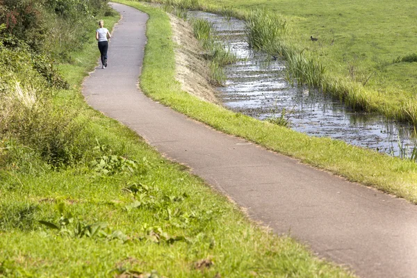 Jogging girl in the netherlands — Stock Photo, Image