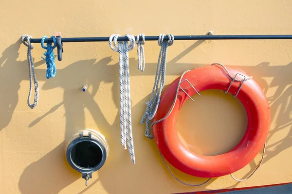 Orange lifebuoy on metal ship — Stock Photo, Image