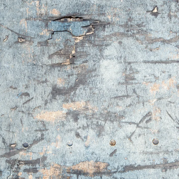 Weathered board with old blue paint and bolts — Stock Photo, Image