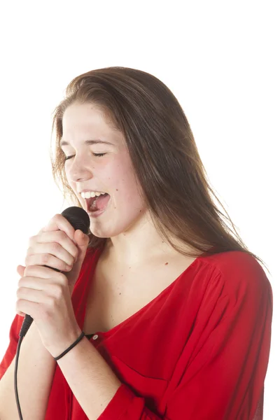 Young brunette with microphone in studio — Stock Photo, Image