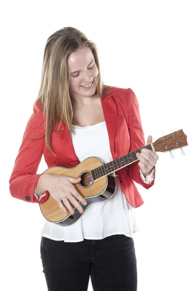 Teenage girl plays ukelele in studio against white background — Stock Photo, Image