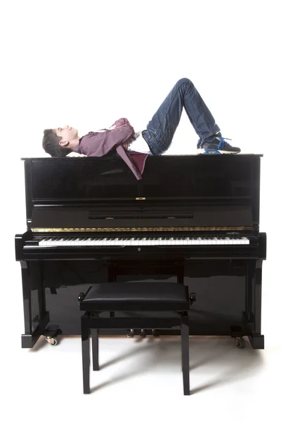 Genç çocuk dik piyano Studio üzerine yatıyor — Stok fotoğraf