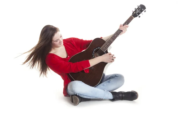 Teenage innehar gitarr i studio Stockfoto