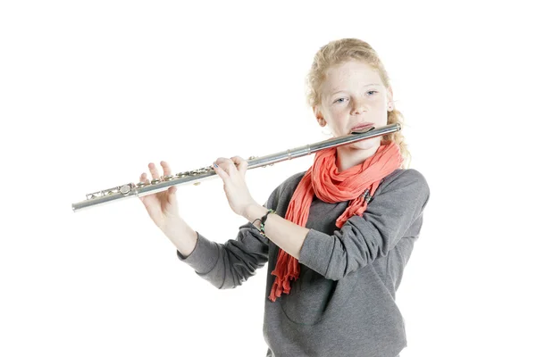 Young girl with red hair and freckles plays flute — Stock Photo, Image