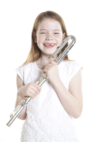 Young red haired girl holds flute in studio — Stock Photo, Image