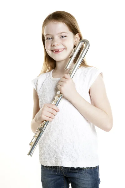 Young red haired girl holds flute in studio — Stock Photo, Image
