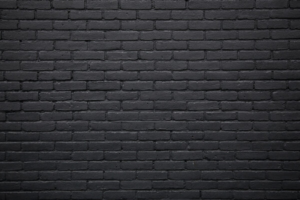 часть черной окрашенной кирпичной стены
