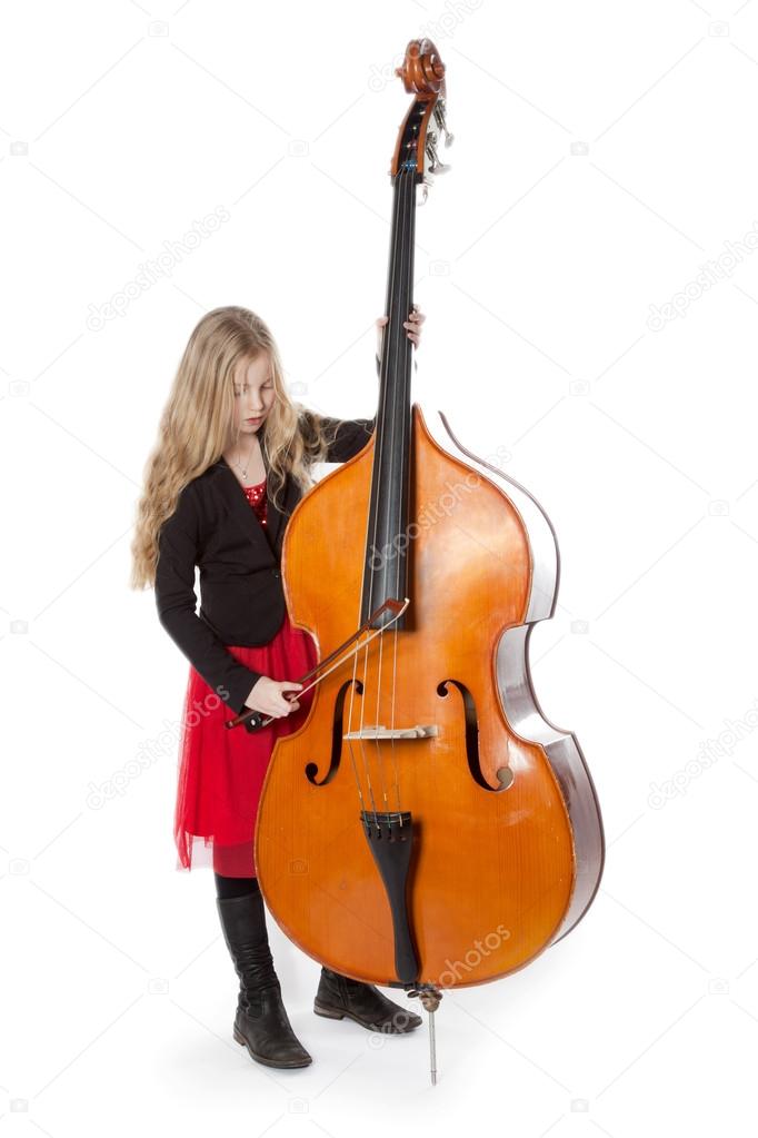 young girl plays double bass in studio