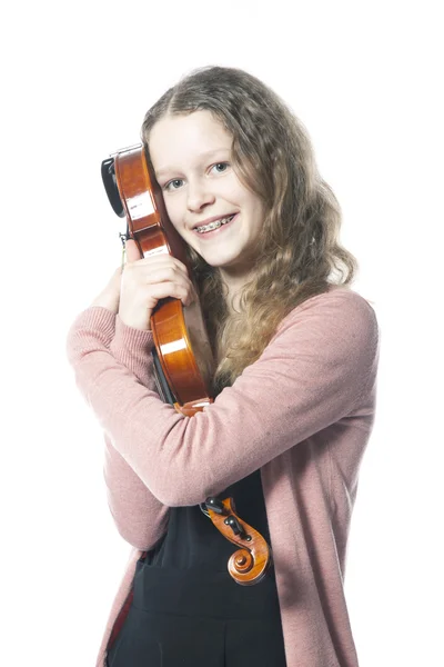 Young girl with blond curly hair embraces violin in studio — Stock Photo, Image