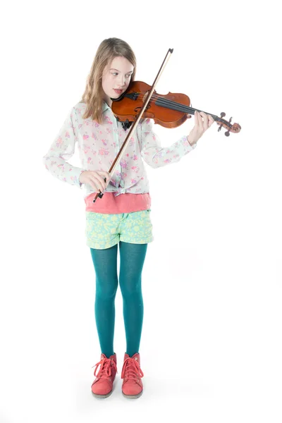 Young girl stands in studio and plays the violin — Stock Photo, Image