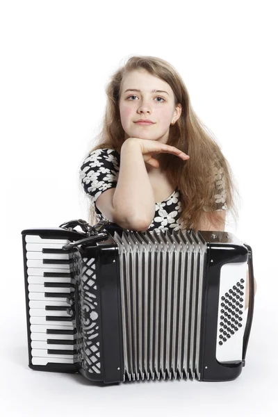 Teenage girl on the floor of studio with accordion — Stock Photo, Image