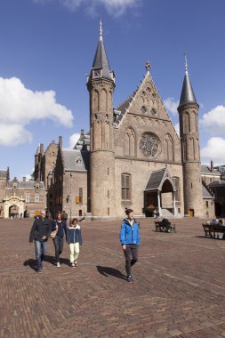 tourists walk on binnenhof in front of ridderzaal in the hague