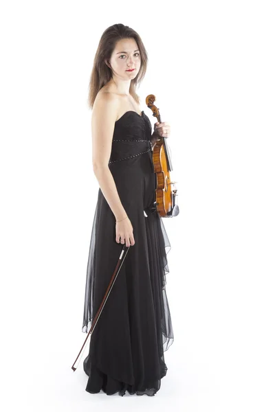 Brunette holds violin in studio against white background — 스톡 사진