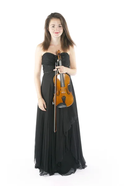 Brunette holds violin in studio against white background — 스톡 사진