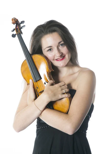 Brunette holds violin in studio against white background — 스톡 사진