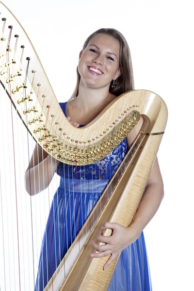 Young caucasian woman with concert harp in studio against white — 스톡 사진