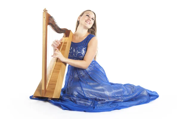 Young caucasian woman in blue dress sits on floor with small har — ストック写真