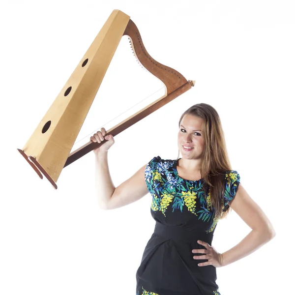 Jovem caucasiano mulher segura pequena harpa no estúdio contra whit — Fotografia de Stock