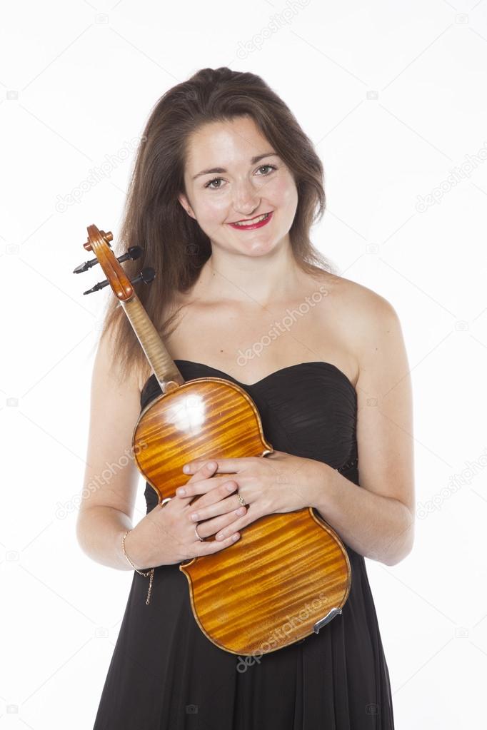 brunette holds violin in studio against white background
