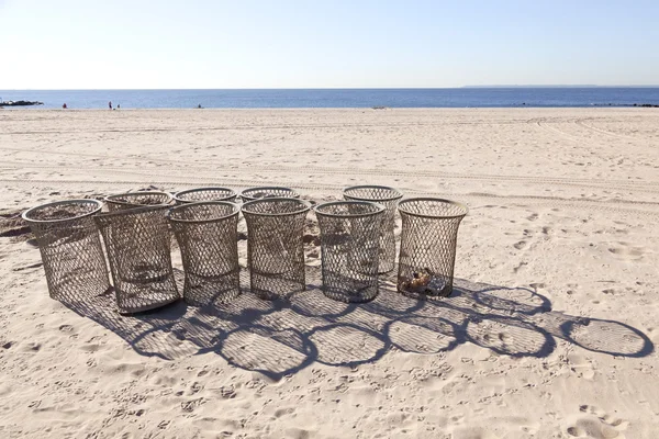 Empty trash baskets on sunny morning beach of coney island — Stock Photo, Image
