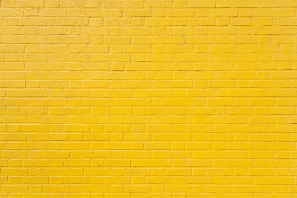 Yatay sarı boyalı tuğla duvar parçası