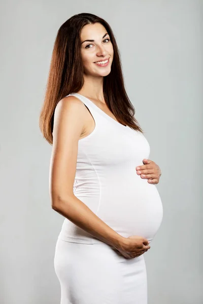Smiling Pregnant Brunette Woman White Clothes Gray Background Happiness Motherhood — Stock Photo, Image