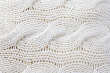 Örgülü beyaz yün örgü. Yakın plan. Geçmişi. Mesaj için yer var. Hobi ve zanaat.