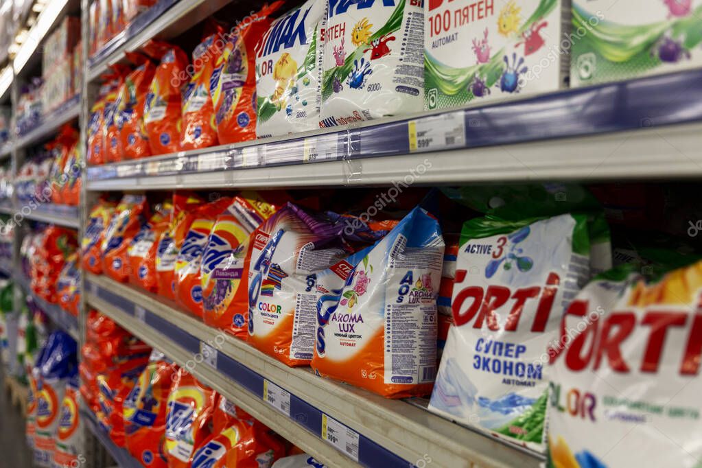Washing powders of different brands on store shelves. Moscow, Russia, 11/25/2020.