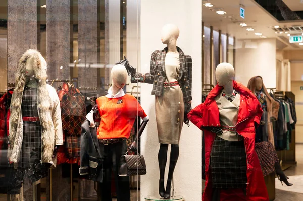 Mannequins in the window of a clothing store. Demonstration of the new collection.