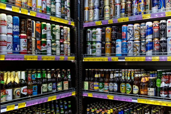 Dükkandaki raflarda şişeler ve bira kutuları. Büyük seçim. Ön manzara. Moskova, Rusya, 12-24-2020.