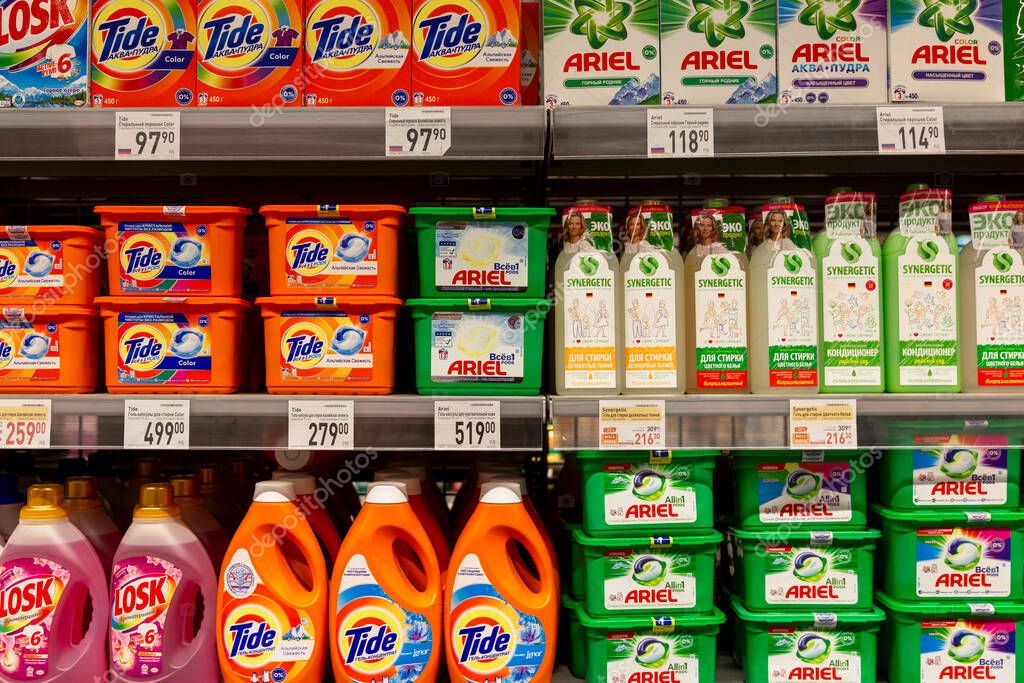 Washing powders and cleaning products on the shelves in the store. Front view. Moscow, Russia, 01-01-2021.