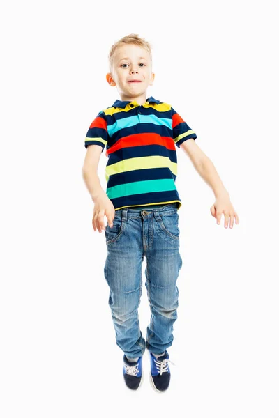 Chlapec Džínách Pestrobarevném Tričku Skáče Bílé Pozadí Svisle — Stock fotografie