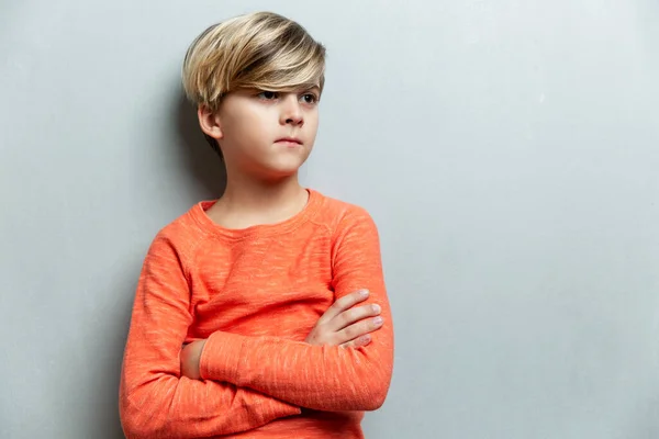 Serious Boy Years Old Orange Jacket Stands Wall Arms Crossed — Stock Photo, Image