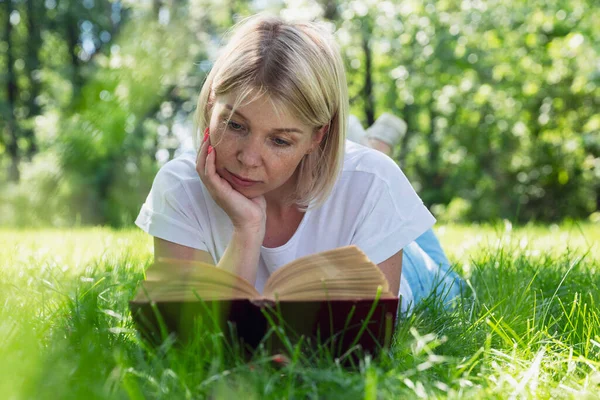 Young Woman Lies Grass Park Reads Book Pretty Blonde Freckles — Foto Stock