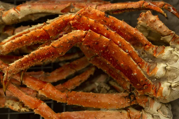 Large crab claws in the store. Close-up. An expensive delicacy.