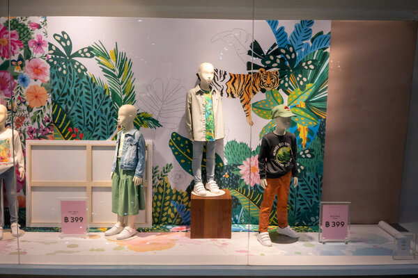 H&M shop at Paradise Park, Bangkok, Thailand, Mar 21, 2021 : Fashionable kids clothing brand in Summer collection window display in front of the shop.