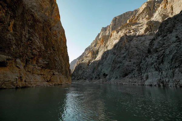 Boat tour on the river and cliffs of a canyon