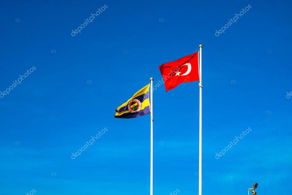 Istanbul Turkey - 1.4.2021: Flags of Fenerbahce SK and Turkey against the blue sky.