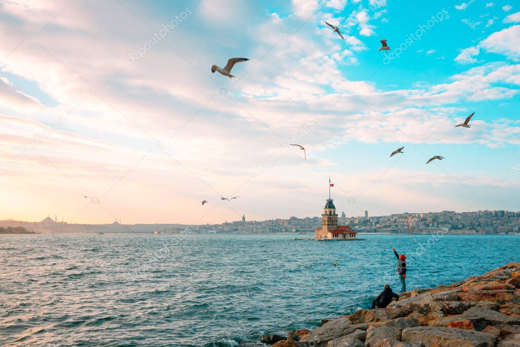 Maiden's Tower and Seagulls at sunset. Kiz Kulesi at sunset in Istanbul. Istanbul background photo. Travel to Istanbul. Sunset and cityscape of Istanbul.