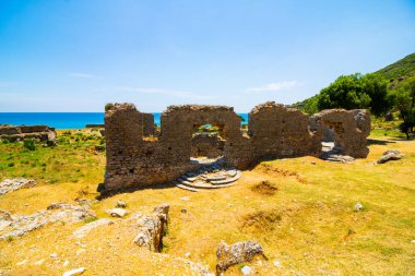 Ruins of Anemurium Ancient City or archaeological Site in Anamur Mersin Turkey. Ancient Roman cities in Turkey. Historical places and landmarks of Turkey.  clipart