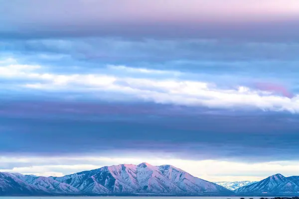 Panorama di maestosa montagna coperta di neve in inverno contro il cielo coperto — Foto Stock