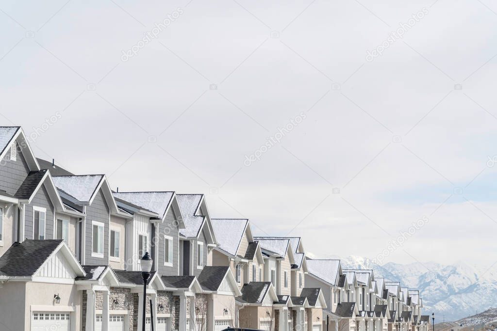 Townhouses exterior on a snowy suburban neighborhood on a cloudy winter day