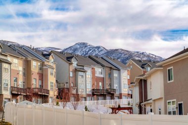 Wasatch dağ zirvesi bulutlu mavi gökyüzü arka planına sahip bir mahalleden görülüyor