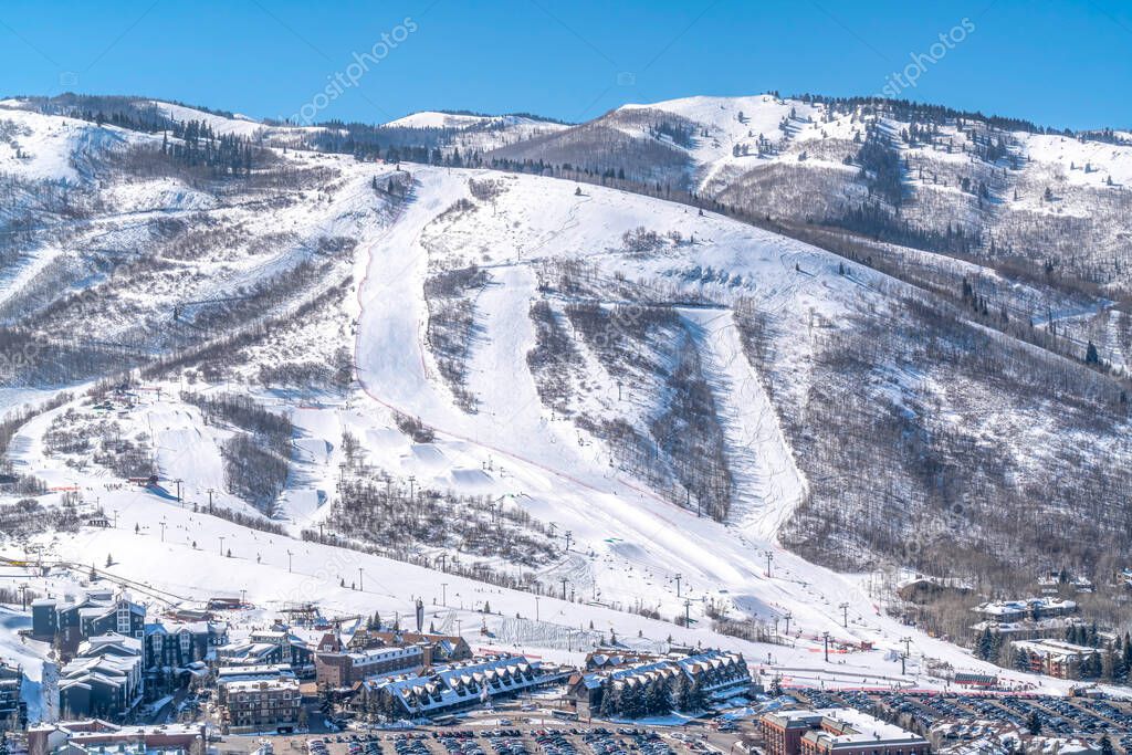 Park City Utah mountain with ski trails and buildings on a snowy scene in winter