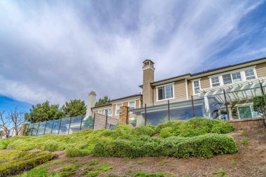 Exterior of homes on a slope with glass fencing in Huntington Beach neighborhood