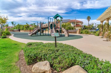 Playground at landscaped park in the neighborhood of Huntington Beach California