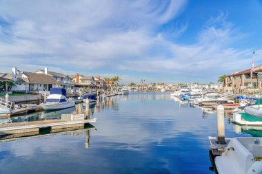 Boats and yachts on clear blue water of scenic harbour in Huntington California
